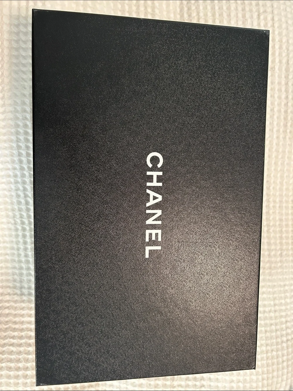 Chanel box - likely phone accessory packaging